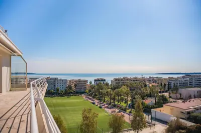 a balcony with a view of a city at Appartement vue mer panoramique in Cannes