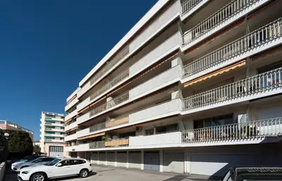 a white car parked in front of a building at Les YUCCAS - 2 pièces Suquet Parking Vue Mer pour 4 personnes in Cannes