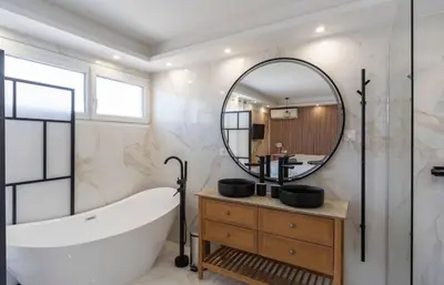 a bathroom with a tub and a large mirror at Les YUCCAS - 2 pièces Suquet Parking Vue Mer pour 4 personnes in Cannes