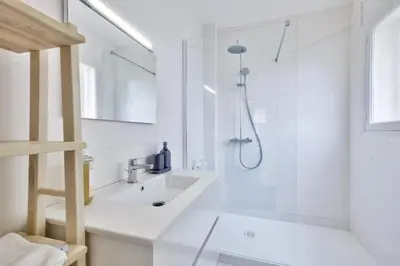 a white bathroom with a sink and a shower at T3 proche de la Croisette et Palais des Festivals in Cannes
