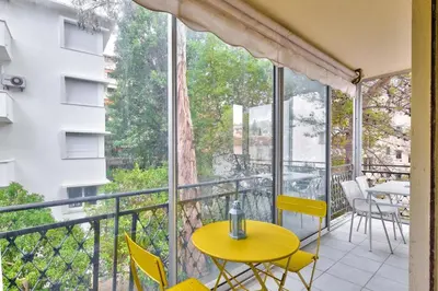 a balcony with a yellow table and chairs at T3 proche de la Croisette et Palais des Festivals in Cannes