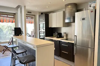 a kitchen with a stainless steel refrigerator and a counter at T2 apartment with terrace in Cannes in Cannes