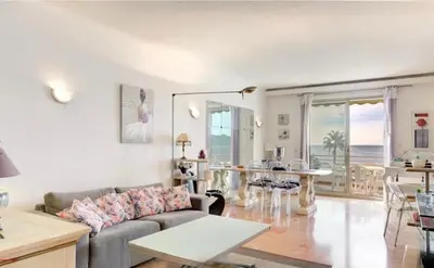 a living room with a couch and a table at Appartement 2 pièces - Vue mer in Cannes