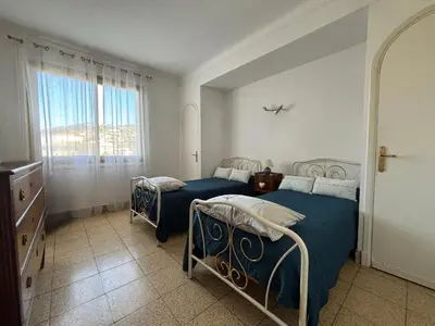 a bedroom with two beds and a window at Appartement 2 pièces - Vue mer in Cannes