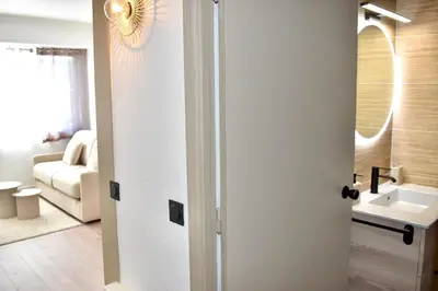 a bathroom with a sink and a mirror at Cosy Studio Cannes in Cannes