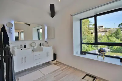 a bedroom with a white bed with two towels on it at Villa Bella Vista - Luxe - Piscine et Sérénité au Cœur du Cannet in Le Cannet