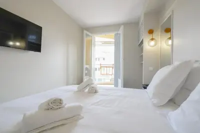 a bedroom with a white bed with towels on it at 