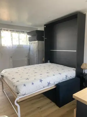 a bedroom with a large bed with blue stars on it at Studio cosy Cannes à 250 m de la plage, pointe Croisette in Cannes