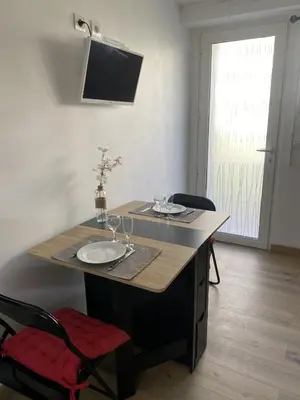 a table with wine glasses on top of it at Studio cosy Cannes à 250 m de la plage, pointe Croisette in Cannes