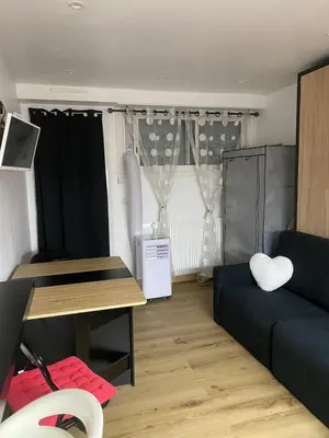 a living room with a couch and a table at Studio cosy Cannes à 250 m de la plage, pointe Croisette in Cannes