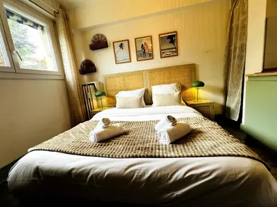 a bedroom with a large bed with two pillows on it at Golden Beach Studio Cannes in Cannes