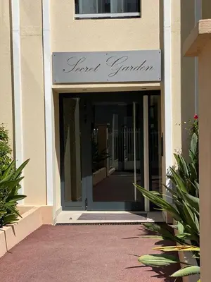 an entrance to a building with a sign on it at Palm beach apartment with swimming pool in a residence in Cannes