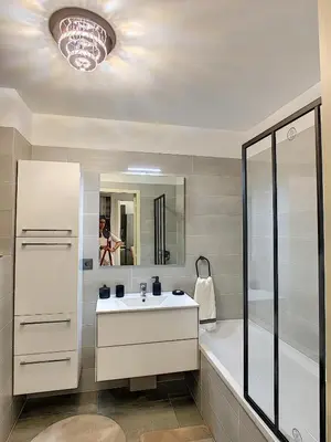 a bathroom with a sink and a shower and a tub at Palm beach apartment with swimming pool in a residence in Cannes