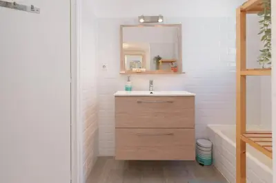 a bathroom with a sink and a mirror and a tub at Le Tassigny #Central #Quiet #Air conditioning #Wifi in Cannes
