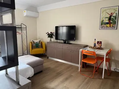 a bedroom with a bed and a tv and a desk at Le Tassigny #Central #Quiet #Air conditioning #Wifi in Cannes