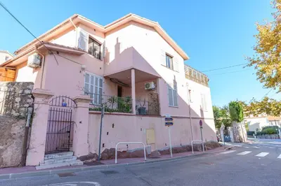 a pink building on the side of a street at Le Tassigny #Central #Quiet #Air conditioning #Wifi in Cannes