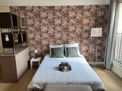a bedroom with a bed and a red and white wall at Le Tassigny #Central #Quiet #Air conditioning #Wifi in Cannes