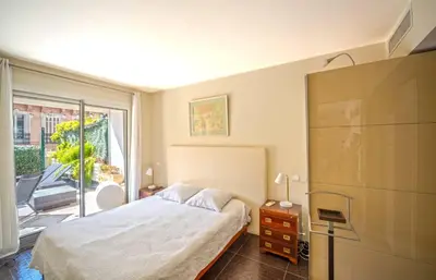 a bedroom with a bed and a sliding glass door at Luxueux 3 Chambres Terrasse de 90m hypercentre - Wifi Clim - 6 pers in Cannes