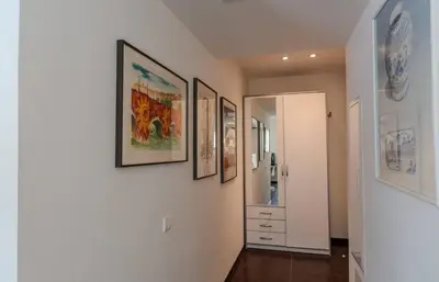 a hallway with four pictures on the wall and a door at Luxueux 3 Chambres Terrasse de 90m hypercentre - Wifi Clim - 6 pers in Cannes