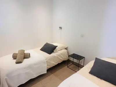 two beds in a room with white walls at One bedroom apartment with a sea view right by the Croisette beaches and the center of Cannes. - 2287 in Cannes