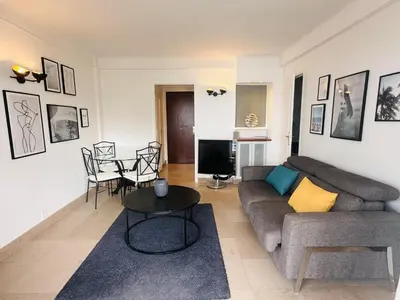 a living room with a couch and a table at One bedroom apartment with a sea view right by the Croisette beaches and the center of Cannes. - 2287 in Cannes