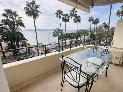 a balcony with a table and chairs and a view of the ocean at One bedroom apartment with a sea view right by the Croisette beaches and the center of Cannes. - 2287 in Cannes