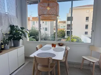 a kitchen with a table and chairs and a window at Bright one bedroom apartment in the center of Cannes13 minutes walk to the Palais des Festivals - 2290 in Cannes