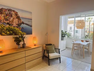 a living room with a table and a painting on the wall at Bright one bedroom apartment in the center of Cannes13 minutes walk to the Palais des Festivals - 2290 in Cannes