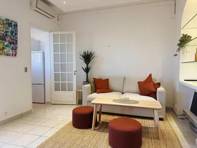 a living room with a couch and a table at Bright one bedroom apartment in the center of Cannes13 minutes walk to the Palais des Festivals - 2290 in Cannes