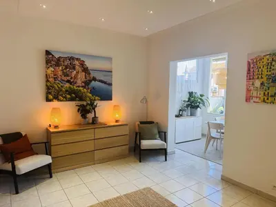 a living room with two chairs and a dresser with a painting at Bright one bedroom apartment in the center of Cannes13 minutes walk to the Palais des Festivals - 2290 in Cannes