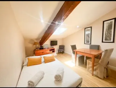a living room with a couch and a table at Appartement, proche du palais des festivals, plage et commerces in Cannes