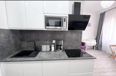 a kitchen with a sink and a microwave at Studio moderne et calme en plein centre in Cannes