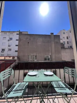 a table and chairs sitting on top of a balcony at Studio moderne et calme en plein centre in Cannes