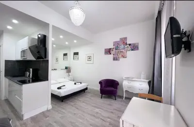 a small white room with a sink and a kitchen at Studio moderne et calme en plein centre in Cannes
