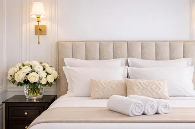 a white kitchen with white cabinets and a sink at Le Suite Napoléon - Luxe et Sérénité au Cœur de Cannes in Cannes