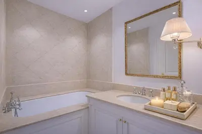 a bath tub with three bottles of wine on it at Le Suite Napoléon - Luxe et Sérénité au Cœur de Cannes in Cannes