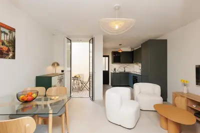 a living room and kitchen with a glass table at Sublime appartement Forville Festival in Cannes
