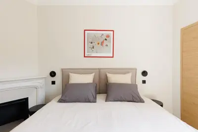a bedroom with a white bed with two pillows at Sublime appartement Forville Festival in Cannes