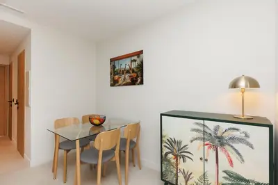 a dining room with a glass table and chairs at Sublime appartement Forville Festival in Cannes