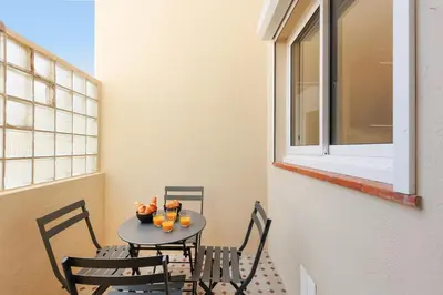 a small table with two chairs and a window at Sublime appartement Forville Festival in Cannes