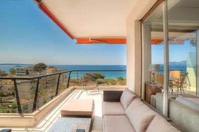 a living room with a couch and a view of the ocean at Immogroom- 2 bedrooms -Panoramic Sea view - Huge in Cannes
