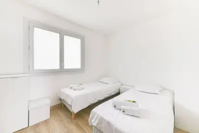two beds in a white room with a window at Immogroom- 2 bedrooms -Panoramic Sea view - Huge in Cannes