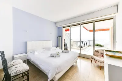a white bedroom with a bed and a large window at Immogroom- 2 bedrooms -Panoramic Sea view - Huge in Cannes