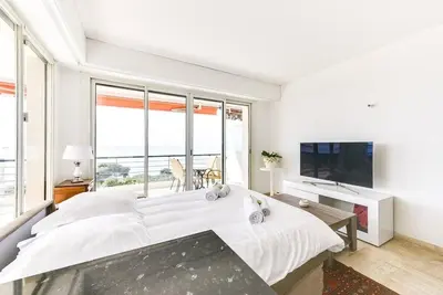a white bedroom with a large bed and a large window at Immogroom- 2 bedrooms -Panoramic Sea view - Huge in Cannes