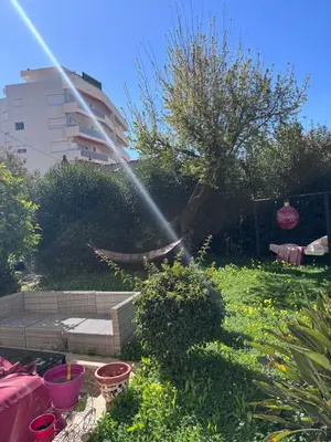 a garden with a sprinkler shooting water into the air at Cannes centre avec parking et jardin in Cannes