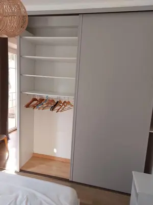a mirrored closet with pairs of shoes in it at Cannes centre avec parking et jardin in Cannes