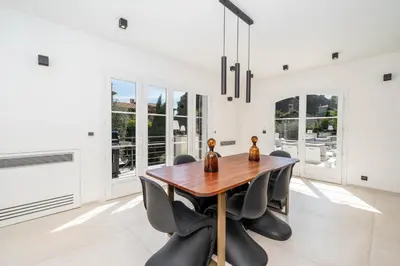 a dining room with a wooden table and chairs at Luxury Villa Cannes,350 m2, 12 pers, 6 ch 6 sdb in Cannes