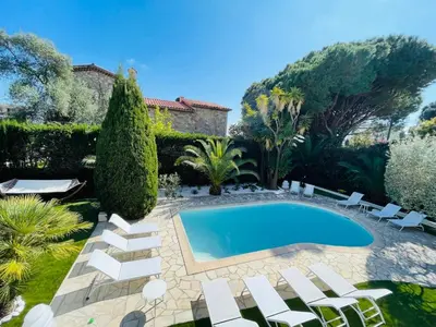 a swimming pool in a yard with white chairs and trees at Luxury Villa Cannes,350 m2, 12 pers, 6 ch 6 sdb in Cannes