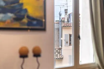 a window with a view of a city at Comfortable apartment in the heart of Suquet in Cannes