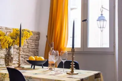 a table with wine glasses and a bowl of fruit at Comfortable apartment in the heart of Suquet in Cannes